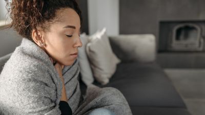 woman wrapped in a blanket because her furnace stopped working woman wrapped in a blanket because her furnace stopped working