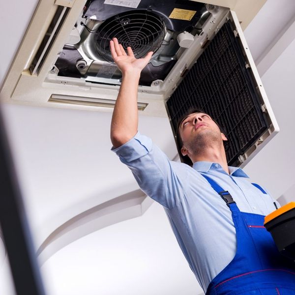 HVAC contractor checking air ducts