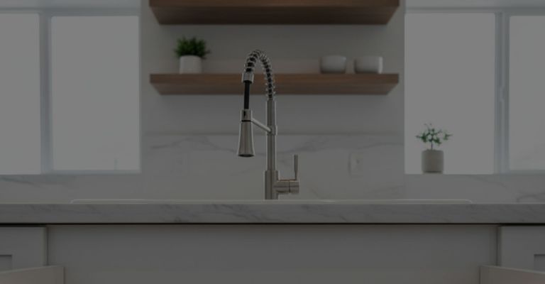 Clean and clear pipes under a modern kitchen sink.