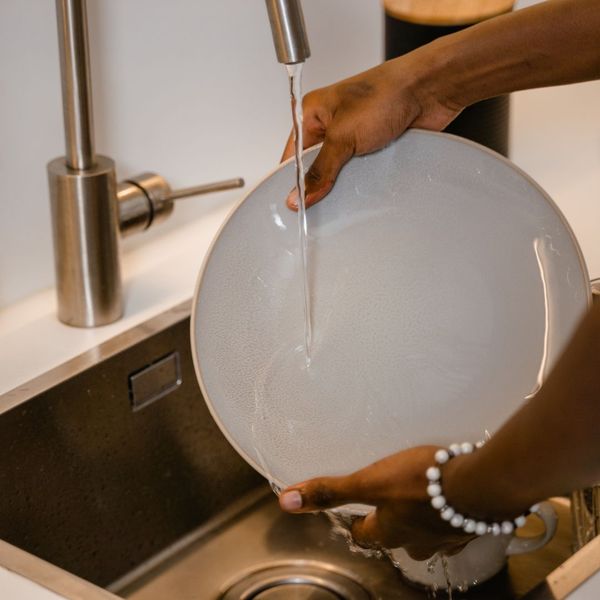 washing dishes in kitchen sink