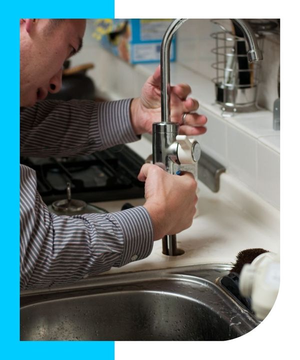 plumber performing maintenance on commercial faucet