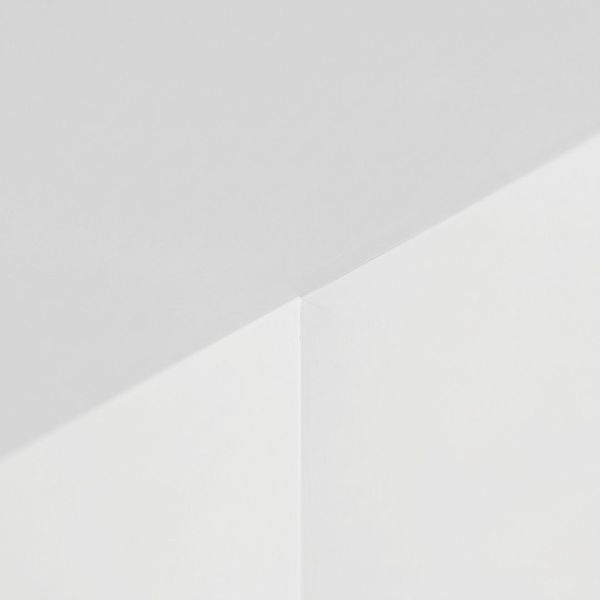 High-quality smooth drywall finish showing seamless transitions between the ceiling and walls in a renovated home.