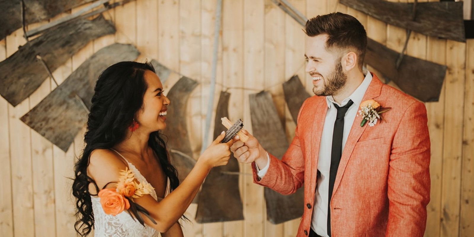 bride and groom holding churros