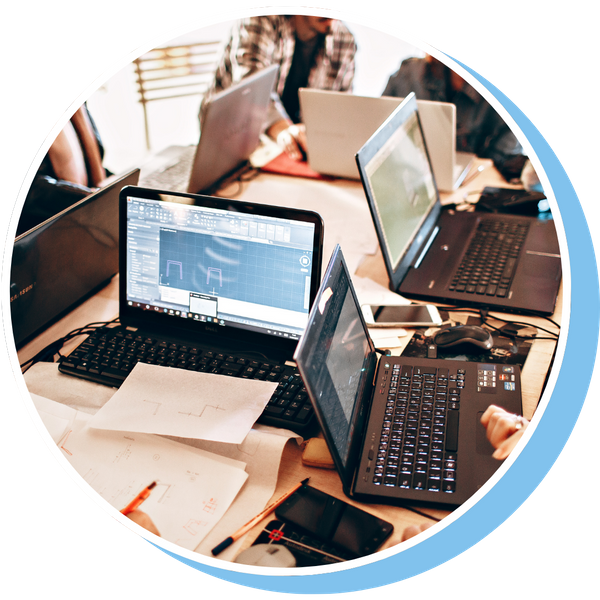 Lots of people using laptops in a small room