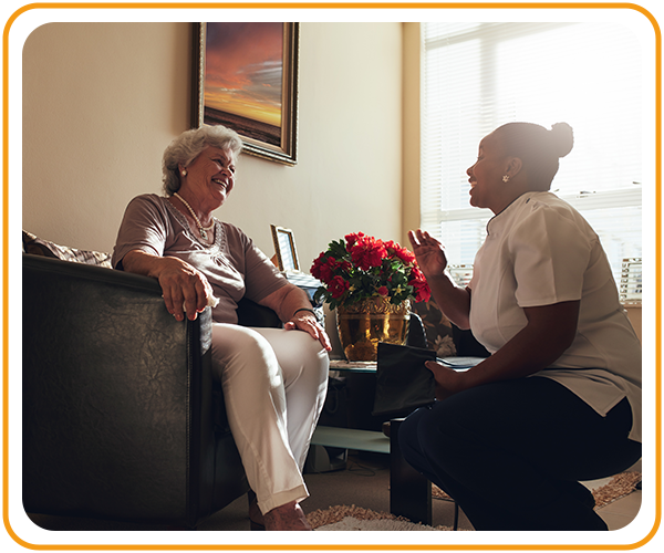 caregiver speaking happily with woman client