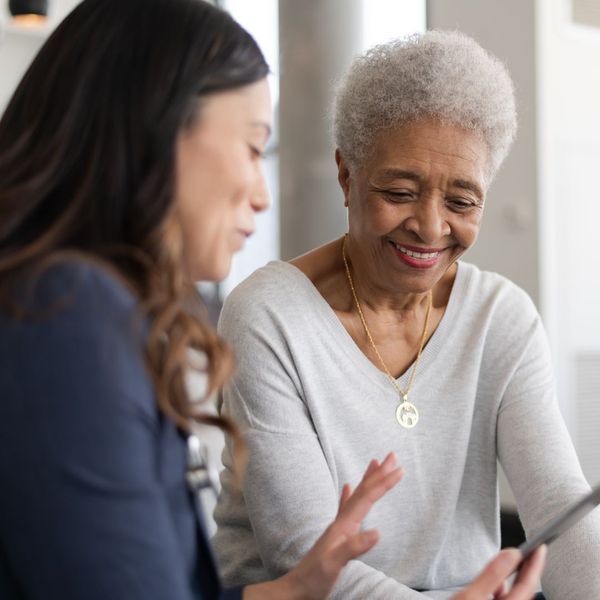 older woman and younger woman looking at cell phone