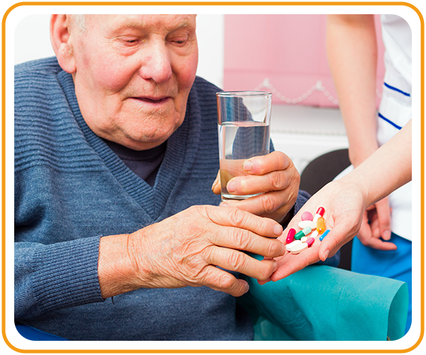 caregiver helping patient with medication