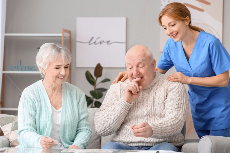 elderly couple and caregiver