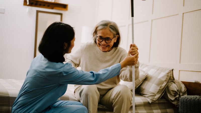 older woman getting help from home care worker