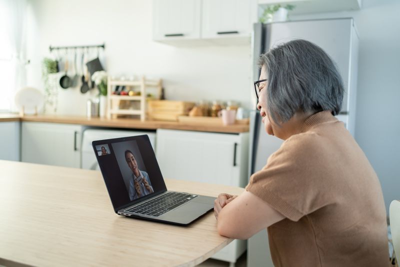 elderly woman using laptop