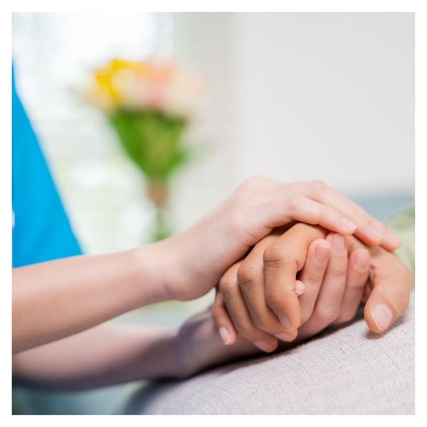 Caregiver holding client's hand