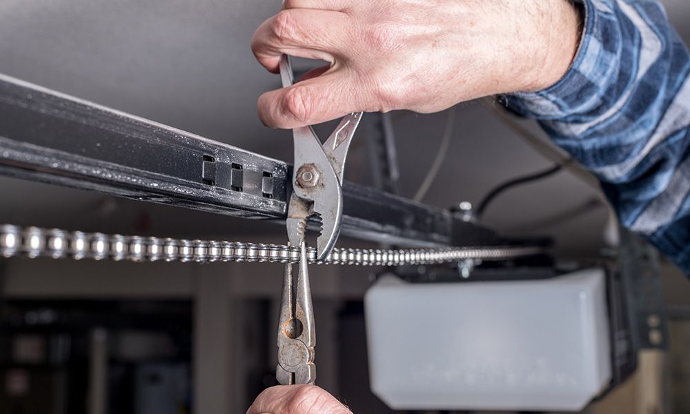 Person repairing garage door opener