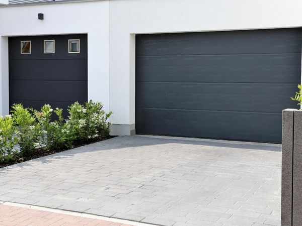 dark garage doors on white house