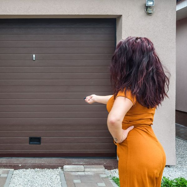 woman using remote to open garage door