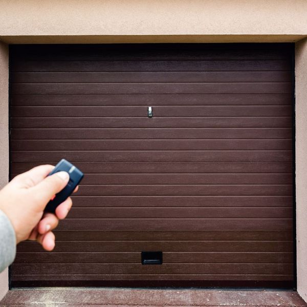 a garage door remote in front of a brown garage door
