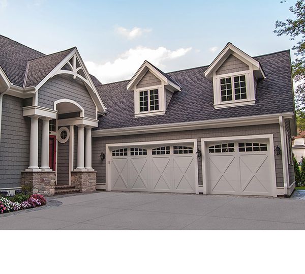 Country house with cream garage doors
