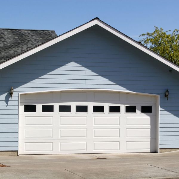 White garage door on blue house
