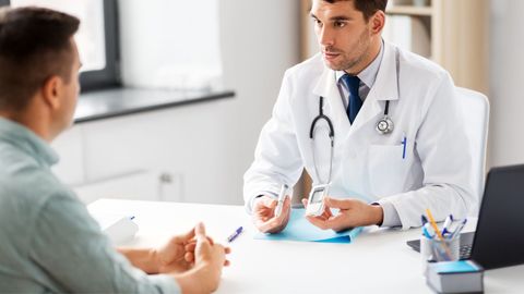 Doctor showing a patient blood sugar testing supplies