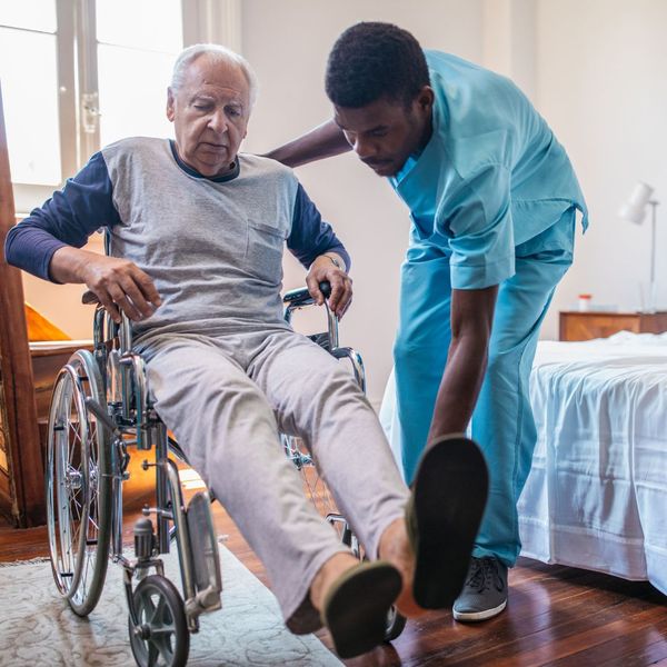 nurse helping man in wheelchair