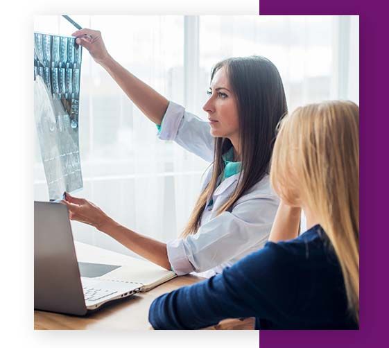 doctor looking over x-ray with student