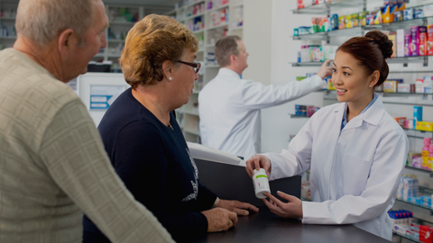 Pharmacist talking to customer