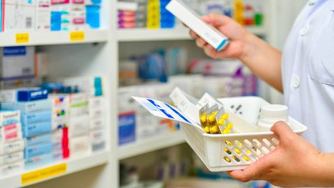 pharmacist holding medications