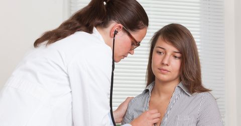 A doctor using a stethoscope.