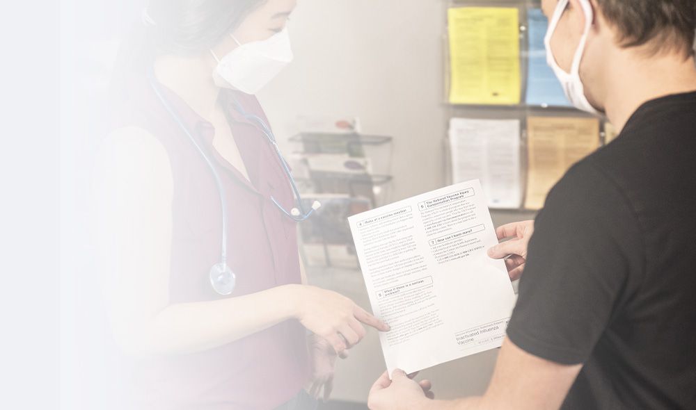 nurse helping patient with form