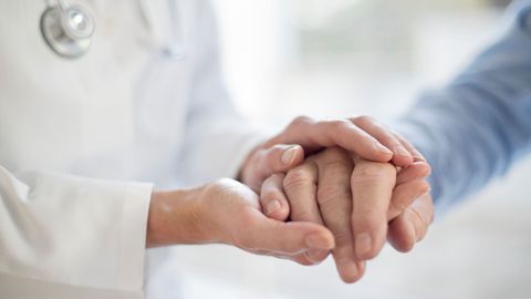 doctor holding a patient's hand
