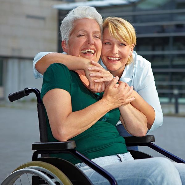 Happy woman in wheelchair with doctor