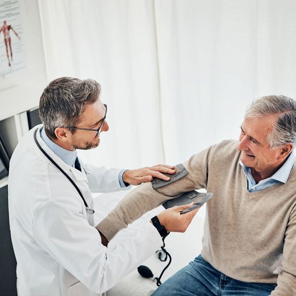 doctor checking a patients blood pressure
