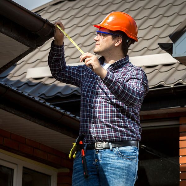 man inspecting roof