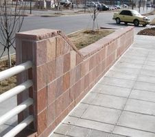 Red cut stones layered into a bridges design