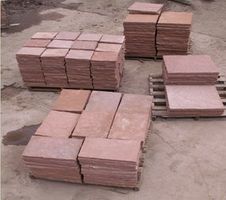 Pallets of red cut stone squares