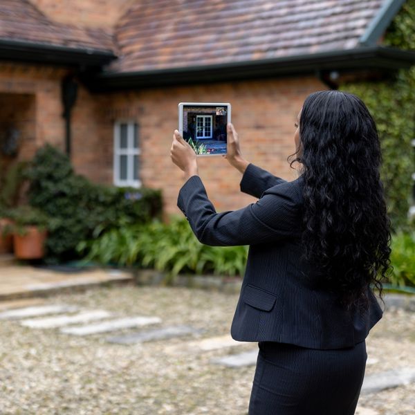 Real estate agent taking photo of a home