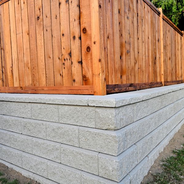 Wooden fence on top off retaining wall