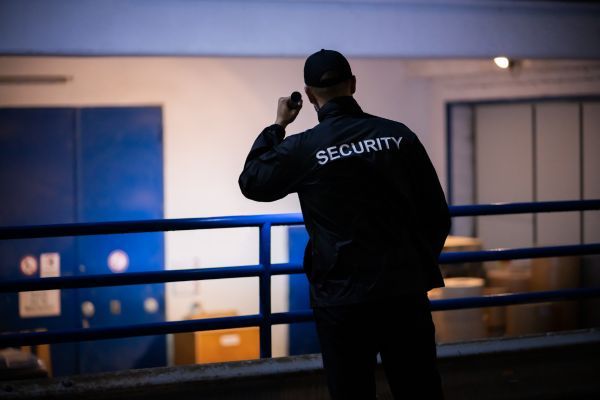 security guard shining flashlight