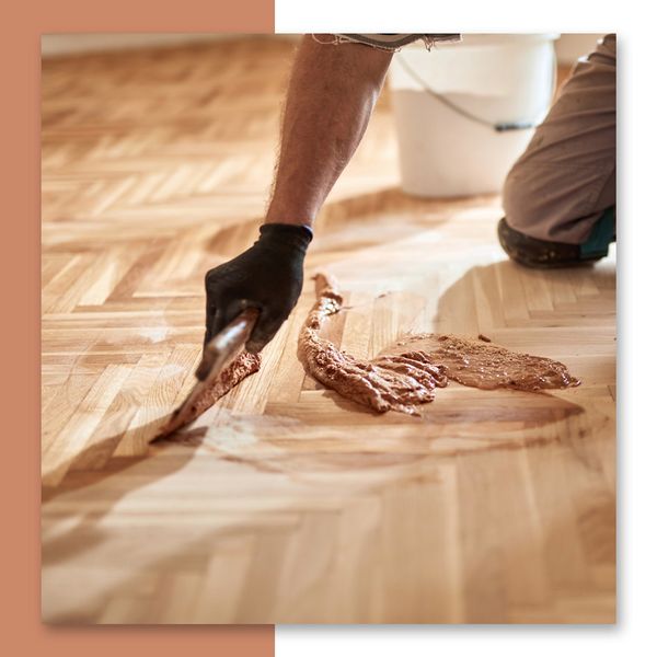 A flooring contractor restoring a hardwood floor
