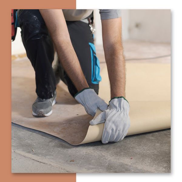 A contractor removing wood floor padding