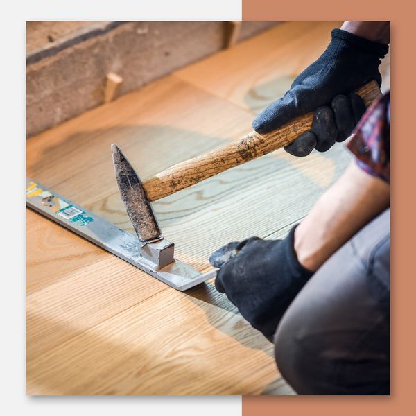 A flooring contractor installing a hardwood floor
