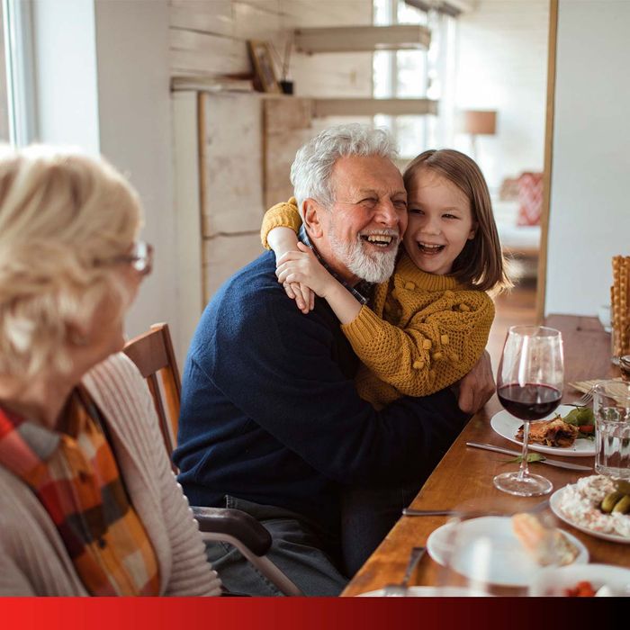 grandpa with granddaughter smiling in home