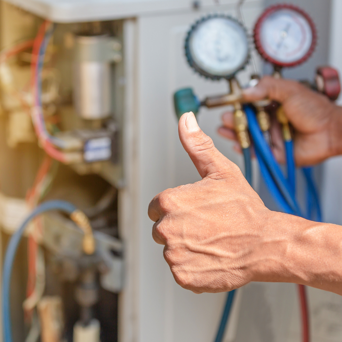 thumbs up in front of hvac system