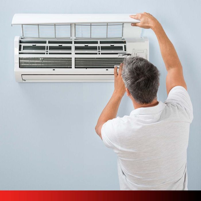 image of man servicing air conditioner