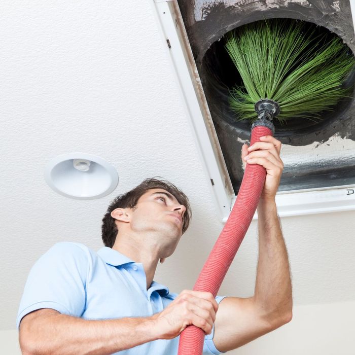 HVAC contractor cleans air duct