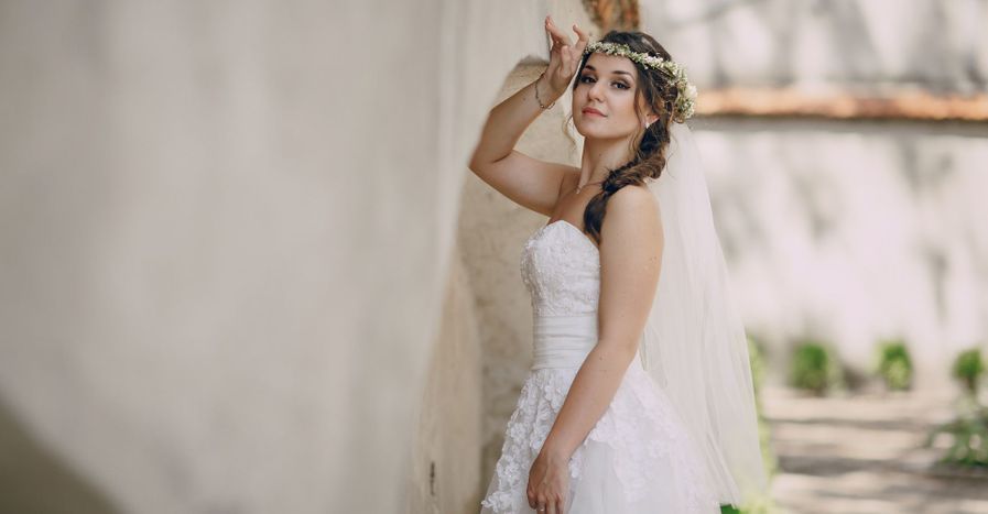 bride posing against a wall