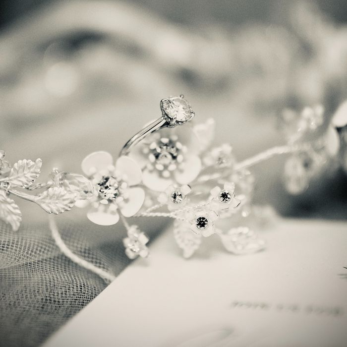 A floral tiara with a ring sitting on it A floral tiara with a ring sitting on it