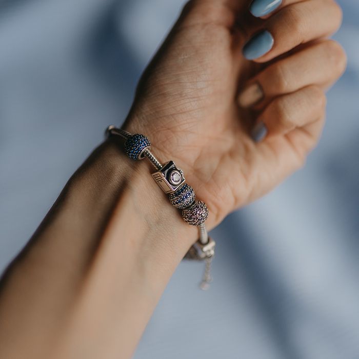 A unique charm bracelet on a woman's wrist