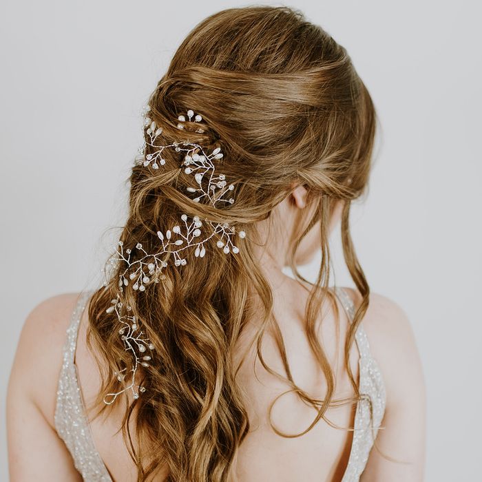 A bride with a delicate hair accent piece