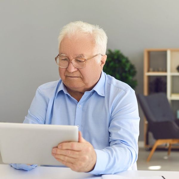 Man looking on his tablet for Medicare plan options