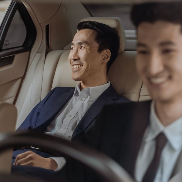 Smiling chauffeur and client